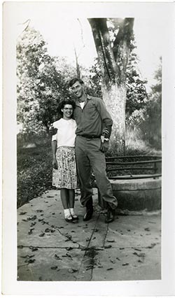 Unidentified woman and man in front of a tree