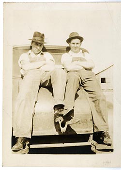 Two unidentified men on a car