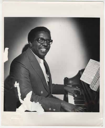 Willie Summerville in suit at piano